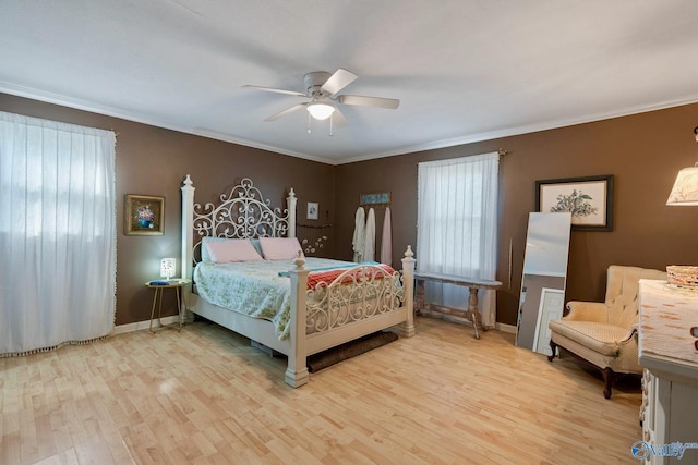 bedroom featuring ceiling fan, crown molding, and light wood-type flooring