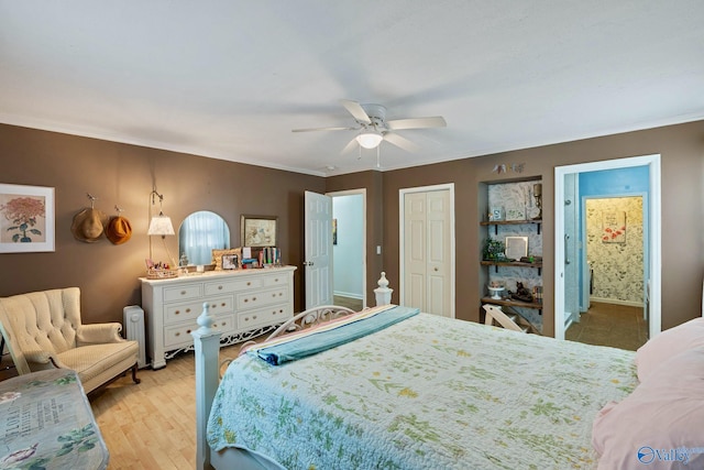 bedroom with light hardwood / wood-style floors, ornamental molding, ensuite bathroom, and ceiling fan