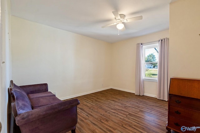 sitting room with ceiling fan and dark hardwood / wood-style flooring