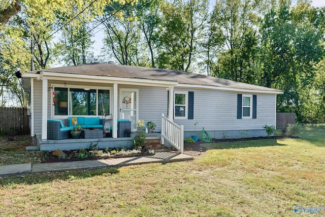 view of front of home with an outdoor living space and a front lawn