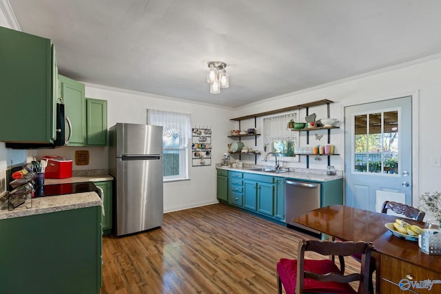 kitchen featuring sink, appliances with stainless steel finishes, dark hardwood / wood-style flooring, and ornamental molding