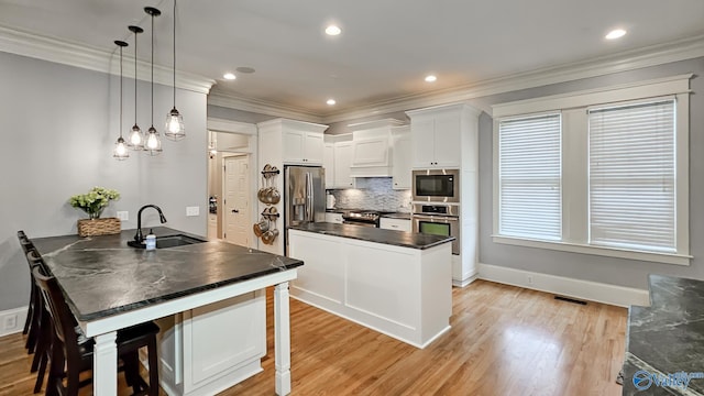 25 Cypress Grove Ln, Huntsville, AL 35824 - kitchen with a sink, stainless steel appliances, dark countertops, a peninsula, and decorative backsplash