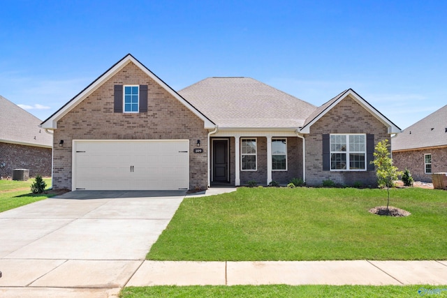 view of front of home with central AC unit, a garage, and a front lawn