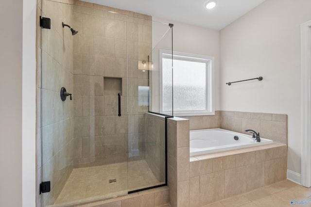 bathroom featuring independent shower and bath and tile patterned flooring