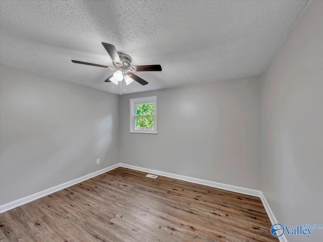 768 County Road 376, Hillsboro, AL 35643 - unfurnished room with wood finished floors, ceiling fan, baseboards, and a textured ceiling