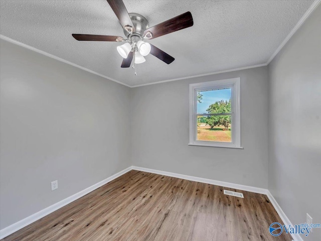 768 County Road 376, Hillsboro, AL 35643 - spare room with wood finished floors, a textured ceiling, baseboards, a ceiling fan, and ornamental molding