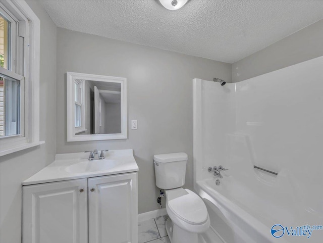 768 County Road 376, Hillsboro, AL 35643 - full bath with toilet, vanity, marble look tiles, bathing tub / shower combination, and a textured ceiling