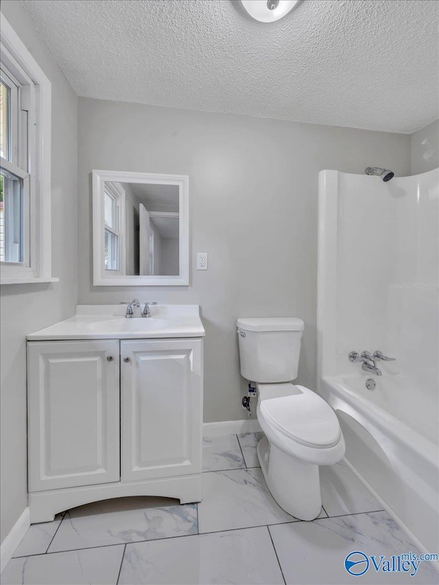 768 County Road 376, Hillsboro, AL 35643 - bathroom featuring marble look tile flooring, toilet, vanity, baseboards, and a textured ceiling