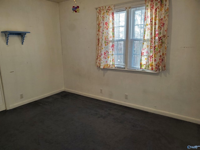 empty room featuring dark colored carpet