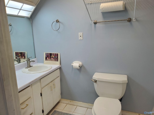 bathroom with toilet, tile patterned flooring, and vanity