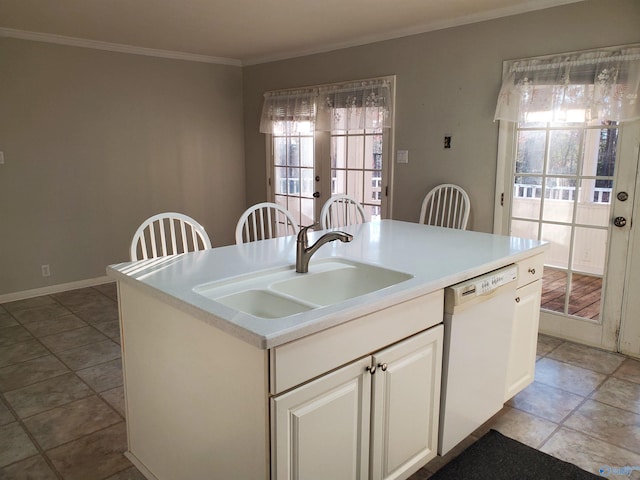 kitchen with crown molding, white dishwasher, sink, french doors, and a center island with sink