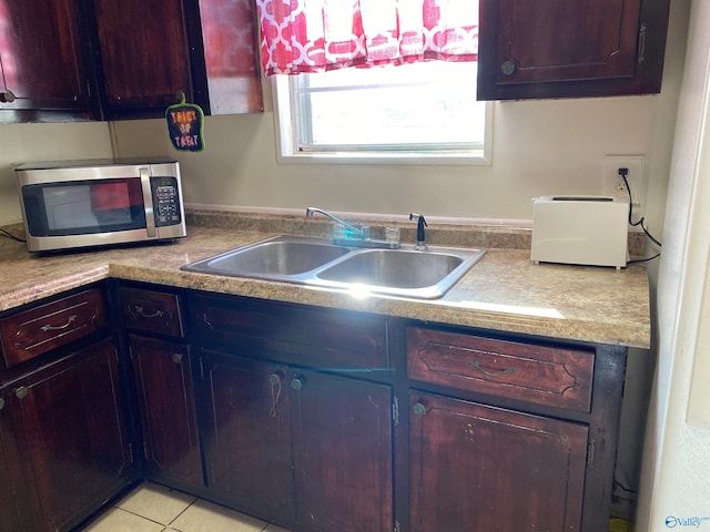 kitchen featuring sink and light tile patterned flooring