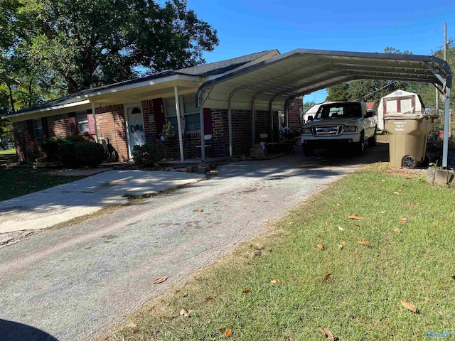 view of parking / parking lot with a lawn and a carport