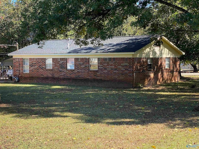 view of side of home with a lawn