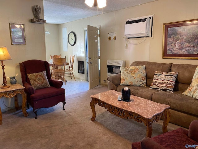 living room featuring a textured ceiling, heating unit, an AC wall unit, and light colored carpet