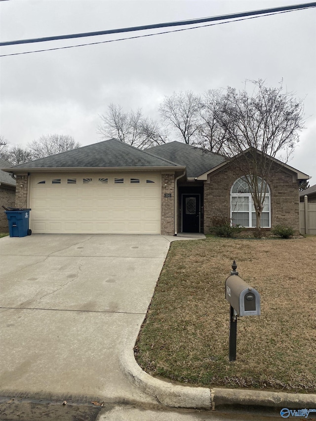 ranch-style house featuring a front lawn and a garage