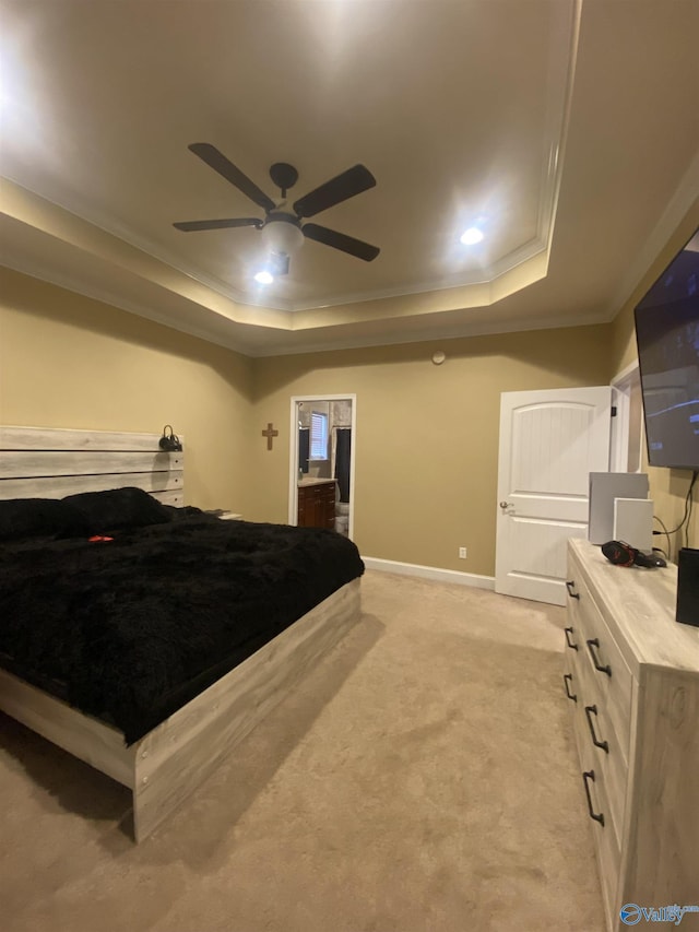 carpeted bedroom with a tray ceiling, ceiling fan, and ornamental molding