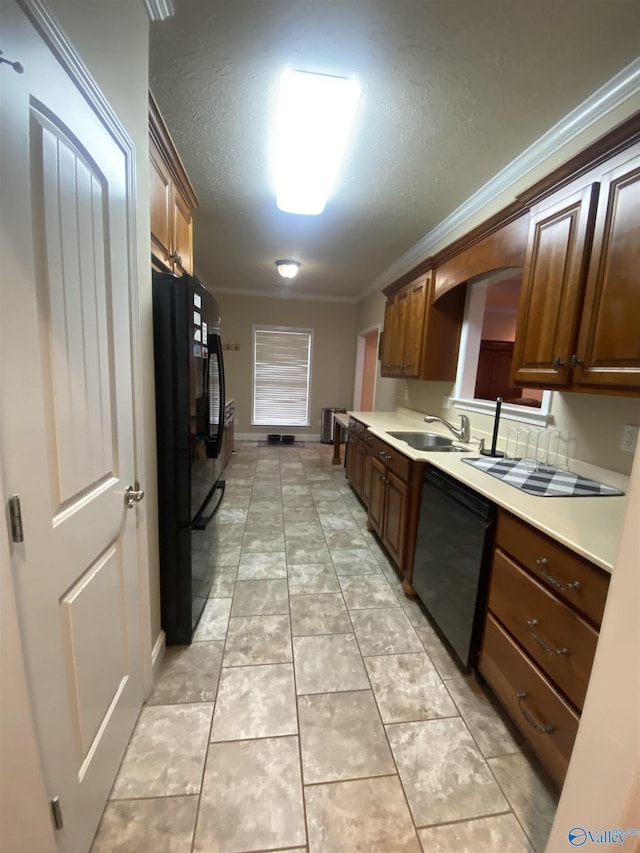 kitchen with a textured ceiling, crown molding, sink, black appliances, and light tile patterned flooring