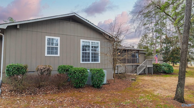 property exterior at dusk with a wooden deck