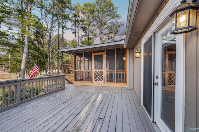 deck at dusk with a sunroom