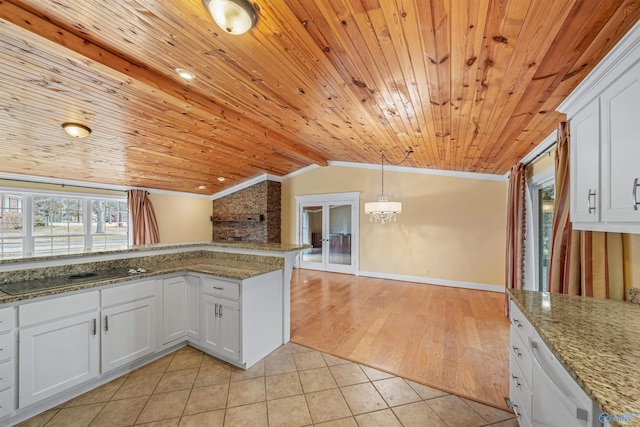 kitchen with black electric cooktop, white cabinetry, stone countertops, and light tile patterned floors