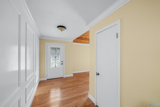 foyer featuring light hardwood / wood-style flooring and ornamental molding