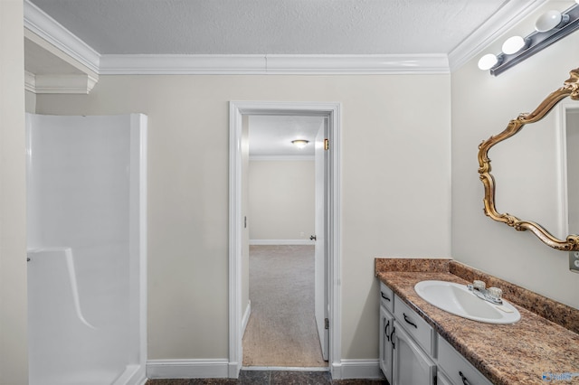 bathroom with crown molding, vanity, walk in shower, and a textured ceiling