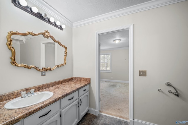 bathroom featuring vanity, ornamental molding, and a textured ceiling