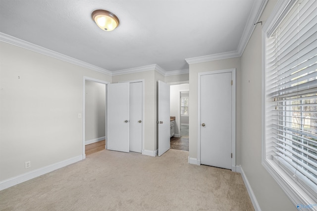 unfurnished bedroom with crown molding and light colored carpet