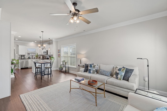 living area featuring dark wood finished floors, recessed lighting, ornamental molding, baseboards, and ceiling fan with notable chandelier