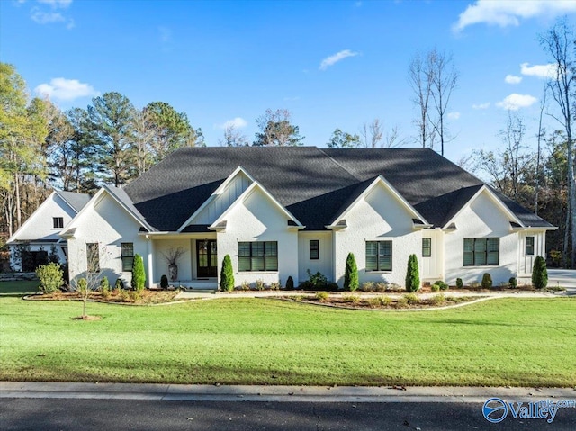 modern inspired farmhouse with a front lawn