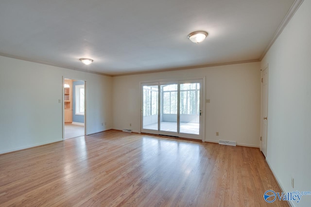 spare room with crown molding and light hardwood / wood-style flooring