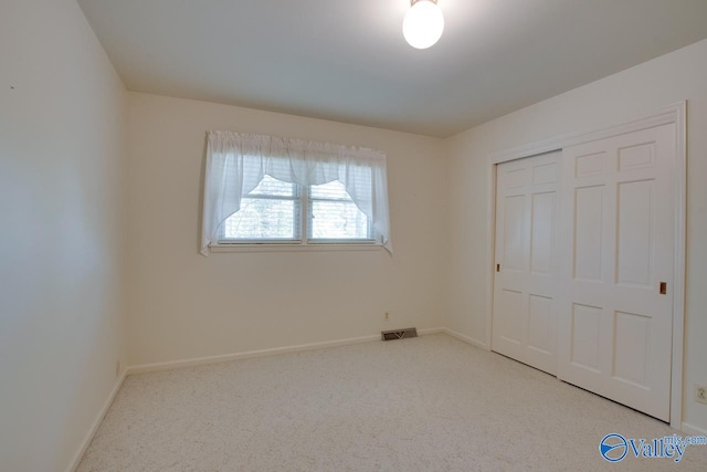 unfurnished bedroom with carpet flooring and a closet