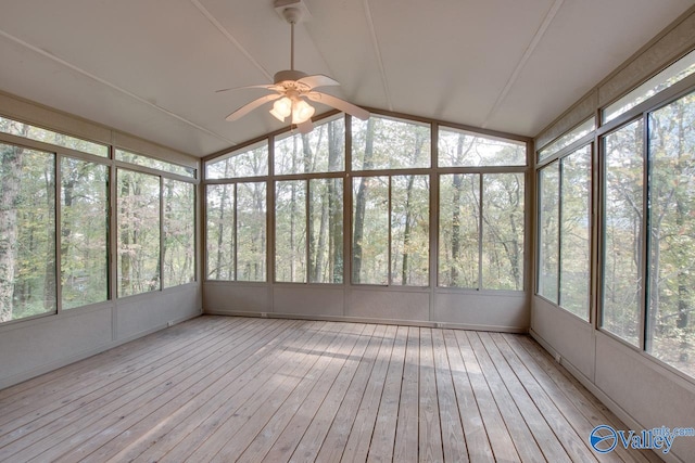 unfurnished sunroom featuring a wealth of natural light, ceiling fan, and lofted ceiling