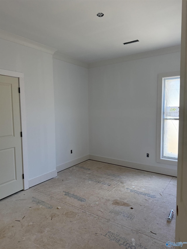 unfurnished room featuring crown molding