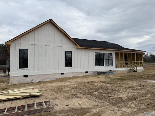 rear view of house featuring a porch