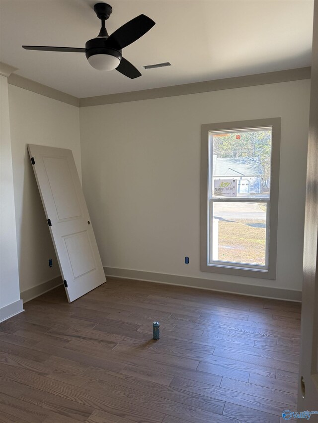 unfurnished room with ceiling fan and dark wood-type flooring