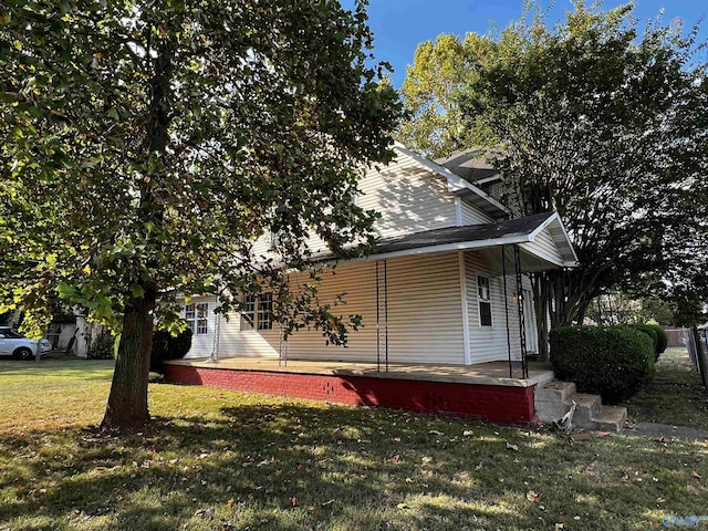 exterior space with covered porch and a front lawn