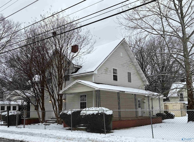 view of front of home featuring a porch, a chimney, and fence