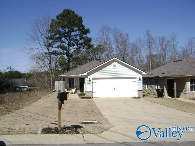 view of front of property featuring an attached garage and concrete driveway