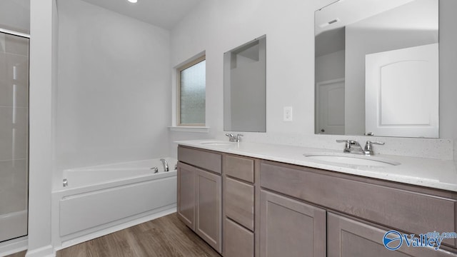 22401 Westminster Dr, Athens, AL 35613 - full bathroom with a garden tub, double vanity, wood finished floors, and a shower