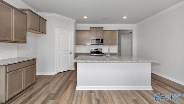 22401 Westminster Dr, Athens, AL 35613 - kitchen featuring stainless steel appliances, a sink, wood finished floors, backsplash, and crown molding