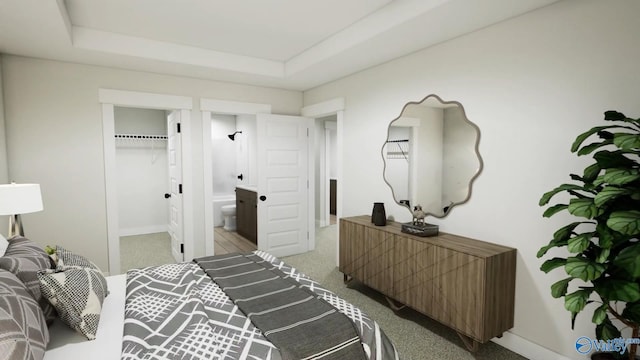 bedroom featuring connected bathroom, a tray ceiling, baseboards, and carpet