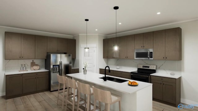 kitchen with crown molding, light countertops, tasteful backsplash, a sink, and stainless steel appliances