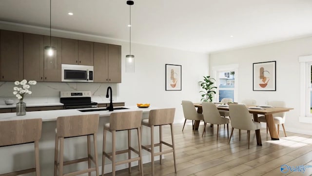 kitchen with decorative backsplash, a sink, light countertops, electric stove, and light wood-style flooring