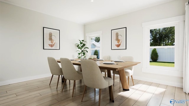 dining area with baseboards and light wood-style flooring