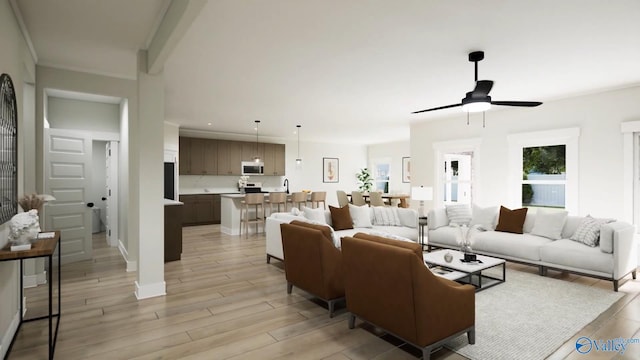 living room featuring a ceiling fan, baseboards, and light wood finished floors