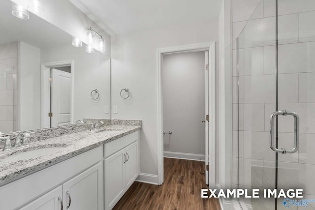 1748 Stampede Cir, Huntsville, AL 35803 - full bath featuring wood finished floors, a sink, a stall shower, and double vanity