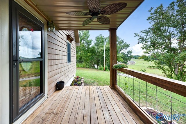 deck featuring a yard and ceiling fan