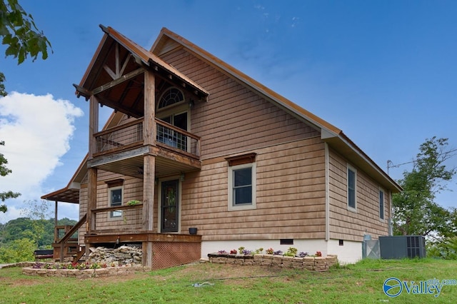 view of front of property featuring a balcony and a front lawn